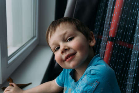 naughty boy smiling at camera, portrait of a child childhoodの写真素材