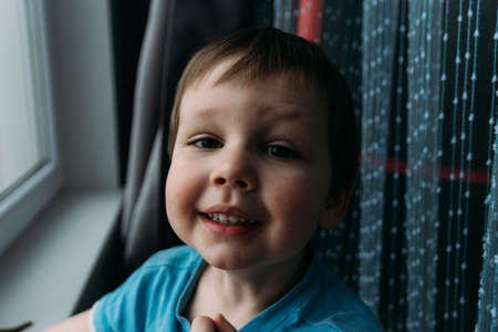 naughty boy smiling at camera, portrait of a child childhoodの写真素材