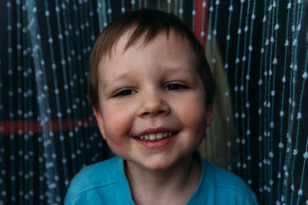 naughty boy smiling at camera, portrait of a child childhoodの写真素材