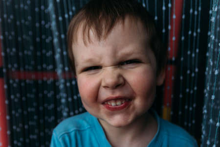naughty boy smiling at camera, portrait of a child childhoodの写真素材