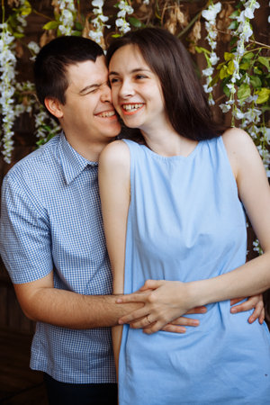 man hugs a girl, smiling, couple in love, blue dress and shirt. date, valentines day,の写真素材