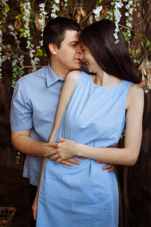 man hugs a girl, smiling, couple in love, blue dress and shirt. date, valentines day,の写真素材