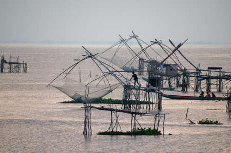 Fishermen catching fish on square dip net at Pakpra, Phatthalung, Thailandの写真素材
