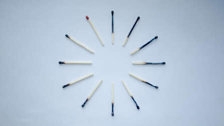Twelve matches placed like clock on white background の写真素材