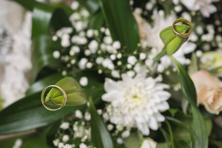 Wedding rings  laying on  bouquet. Macro shot.の写真素材