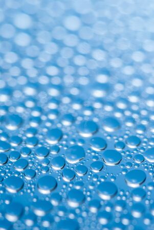 close-up of water drops on the blue background.の写真素材