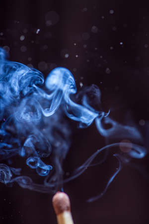 Match with smoke on black background. With copyspaceの写真素材