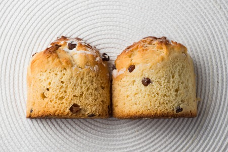 Homemade carrot muffin with empty space on white fabric background. Copyspace top view.