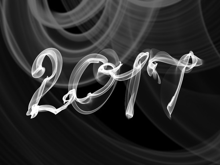 Happy new year 2017 isolated numbers written with smoke or fire on black blurred bokeh background...