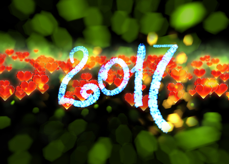 Happy new year 2017 isolated numbers written with light on dark bokeh background and red flying hearts 3d illustration.の写真素材
