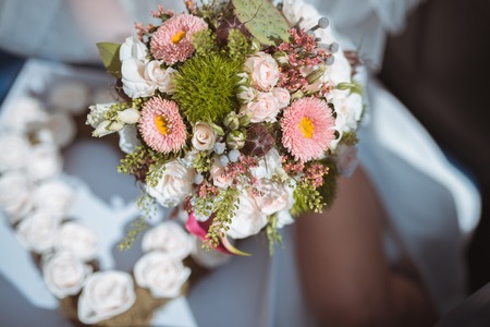 wedding bouquet of gorgeous white roses at brides handの写真素材
