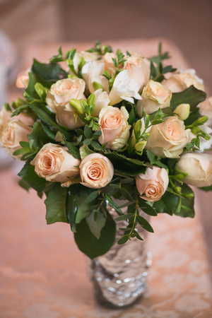 wedding bouquet foll of pink roses for Valentines Day in the vase one the table. selective focus macro shot with shallow DOFの写真素材