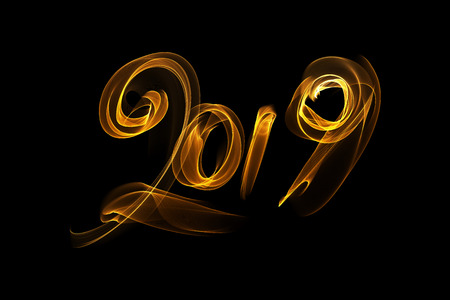 Happy new year 2019 isolated numbers lettering written with fire flame or smoke on black backgroundの写真素材