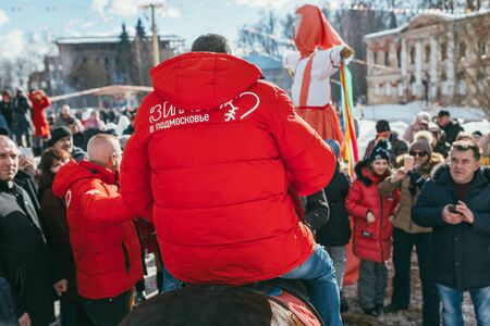 MOSCOW REGION, FRYAZINO, GREBNEVO ESTATE - MARCH 09 2019: Samy Naceri French star and actor of Taxi films mount a horse in front of big crowd visiting the Grebnevo estate during Maslenitsa celebrationのeditorial素材