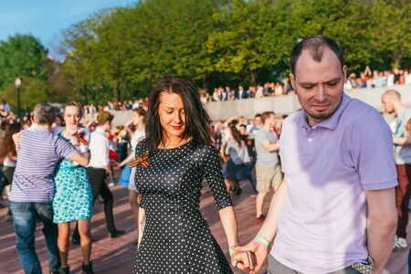MOSCOW, RUSSIA-MAY 09, 2015: people are dancing outdoors in the Park on Pushkinskaya embankment at...