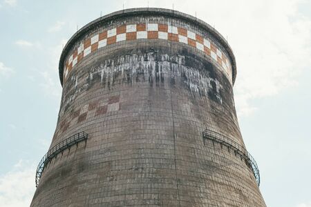 incredibly huge, old, industrial chimney made of concrete blocks. Concept of preserving the...