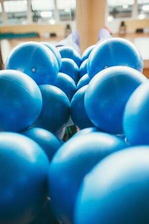 big blue rubber balls in the gym near the mirror. Selective focus macro shot with shallow DOFの写真素材