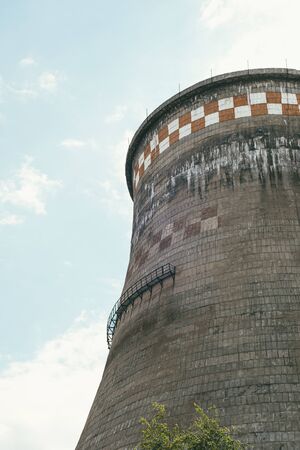 incredibly huge, old, industrial chimney made of concrete blocks. Concept of preserving the...