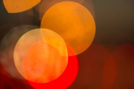 Abstract blurred background. Burning lights and light bulbs on the background of the night city. Selective focus macro shot with shallow DOF.の写真素材