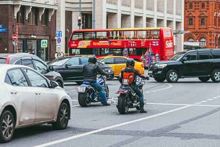 Moscow, Russia - JULY 7, 2017. 2 motorcyclists in black leather suits sit on Harley Davidson motorcycles and ride along the roadway with mashinamiのeditorial素材