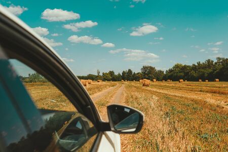 Side view from the car with a view mirror. Spring travel time. The concept of freedom and...