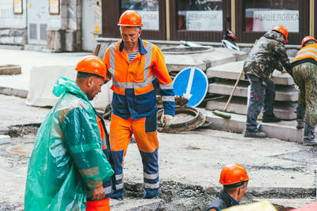 Moscow, Russia - JULY 7, 2017: men workers repairing the road on the streets of Moscow