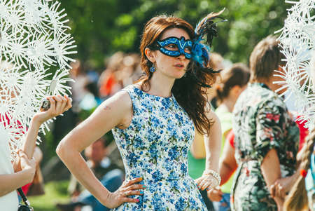 Moscow, Russia - JUNE 1, 2014: A woman in a  carnival mask and a blue dress in Gorky Parkのeditorial素材