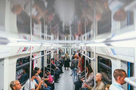 MOSCOW, RUSSIA - JULY 7, 2017: Passengers in a subway car and a lone elderly woman standsのeditorial素材