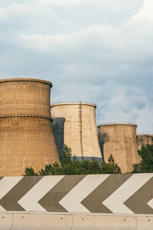 The factory releases smoke into the sky from pipes polluting the atmosphere.の写真素材