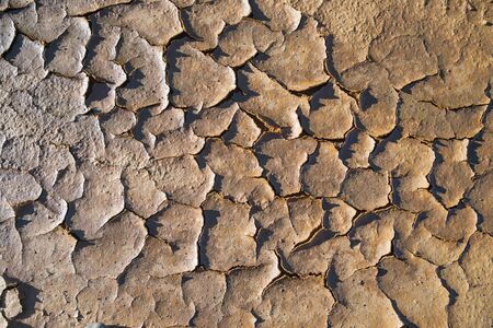 Background texture of dry cracked soil dirt sand or earth during drought.の写真素材