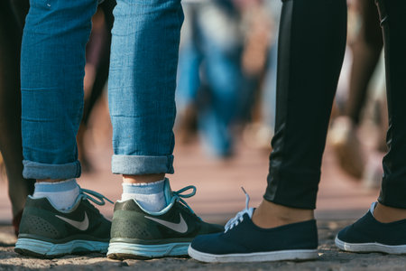 MOSCOW, RUSSIA-MAY 09, 2015: people are dancing outdoors in the Park on Pushkinskaya embankment at sunny day. nike sneakers on womens feet in the foregroundのeditorial素材