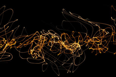 illustration of fire luminous curly lines representing sound wave isolated on black background with copy space. Banner for your designの写真素材