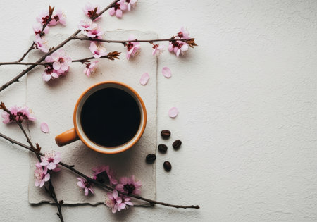 Coffee cup and blooming branch on white textured backgroundの素材