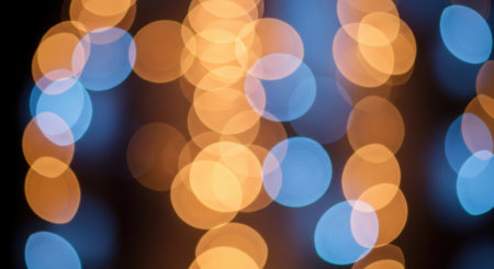 Soft, blurred circles of light in warm orange and cool blue hues create a dreamy atmosphere.の素材