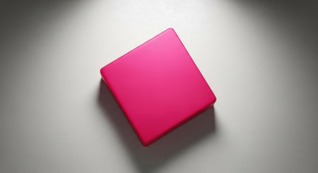 A striking magenta diamond shape is illuminated by a spotlight, casting a soft shadow.の素材