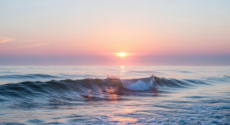 Gentle ocean waves catch the warm glow of a pastel sunrise, creating a peaceful seascape.の素材