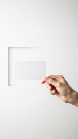 Hand holding transparent square paper isolated on white backgroundの素材