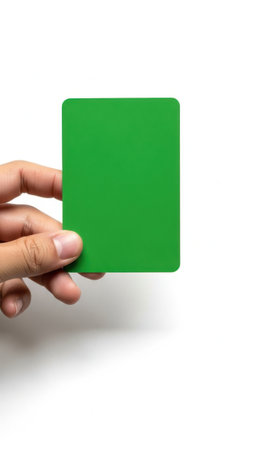 Hand holding green card isolated on white backgroundの素材