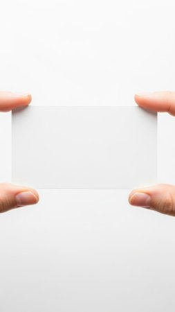 Hands holding paper rectangle isolated on white backgroundの素材