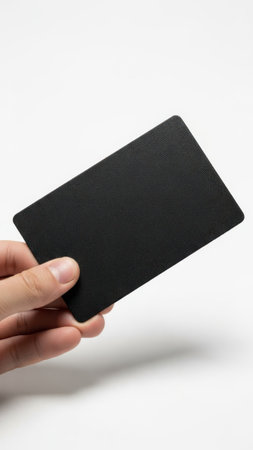 Hand holding black card isolated on white backgroundの素材