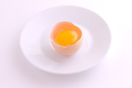 raw broken egg on plate