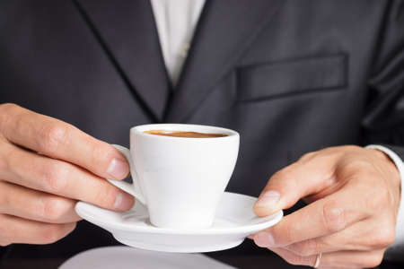 Businessman makes coffee break  Close upの写真素材