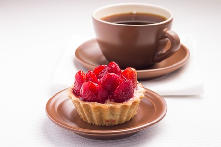 Strawberry dessert in Waffle Basket with Cup of Hot Teaの写真素材