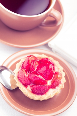 Strawberry dessert in Waffle Basket with Cup of Hot Teaの写真素材