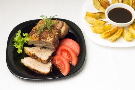 Top View on Baked Sliced Meat with Grilled Potatoの写真素材