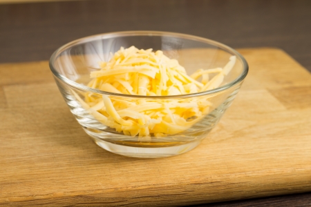 Grated Cheese on cutting boardの写真素材
