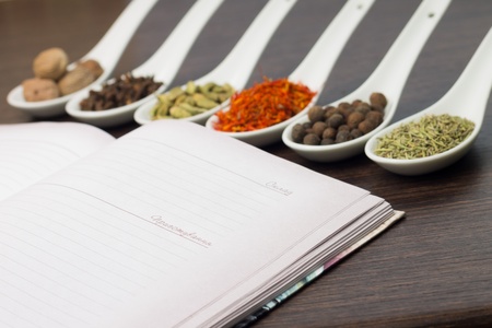 Opened Kitchen book with various of Spicesの写真素材