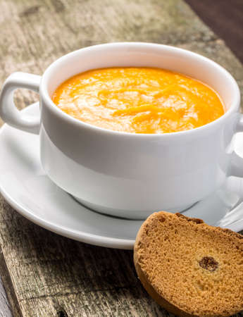 Sweet pumpkin porridge at old wood plank