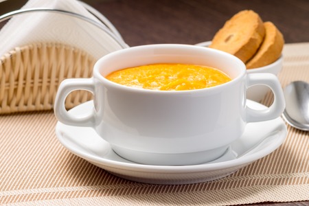 Sweet Pumpkin porridge in white bowl at the tableの写真素材