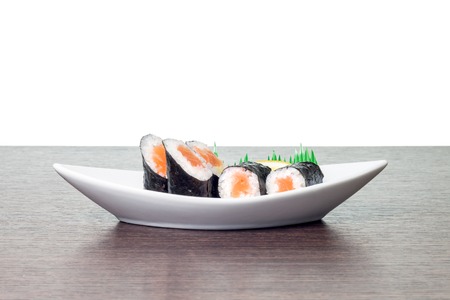 Seafood sushi in white boat plate. Maki sushi in dish with copyspaceの写真素材